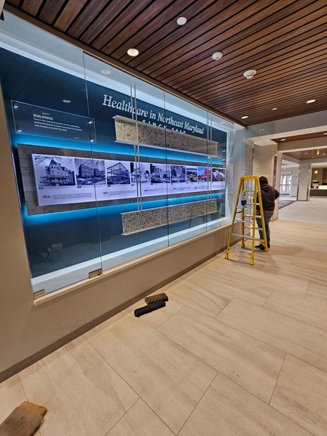 Illuminated glass display wall panels in a commercial lobby in Baltimore, MD