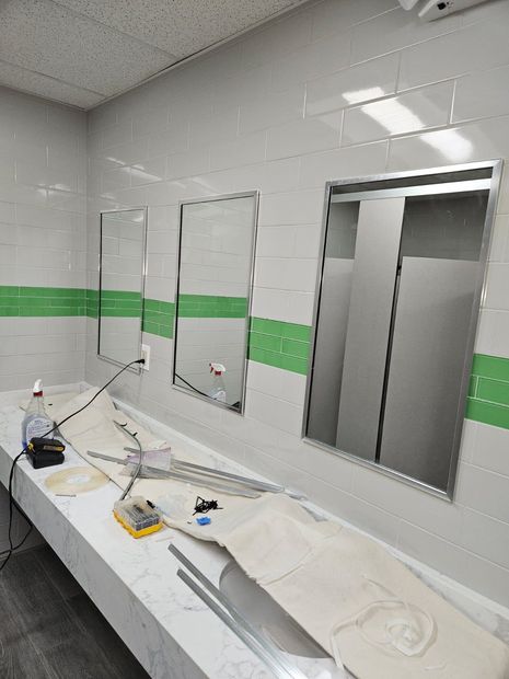 Commercial restroom mirrors with stainless steel frames installed in Baltimore, MD