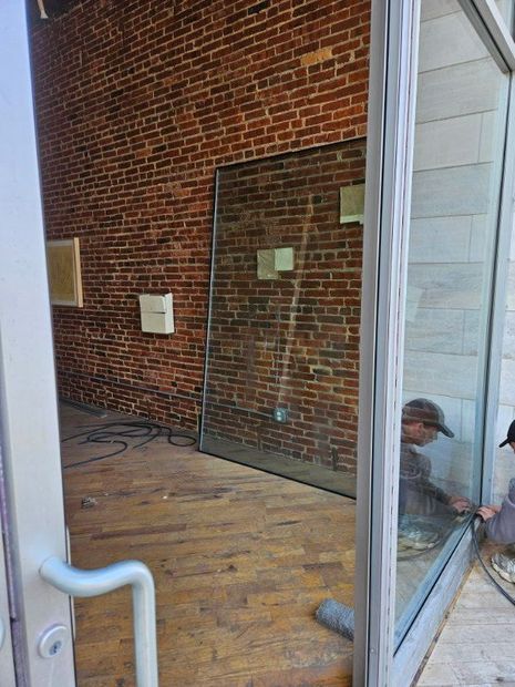 Commercial storefront glass door installed in an exposed brick interior in Baltimore, MD