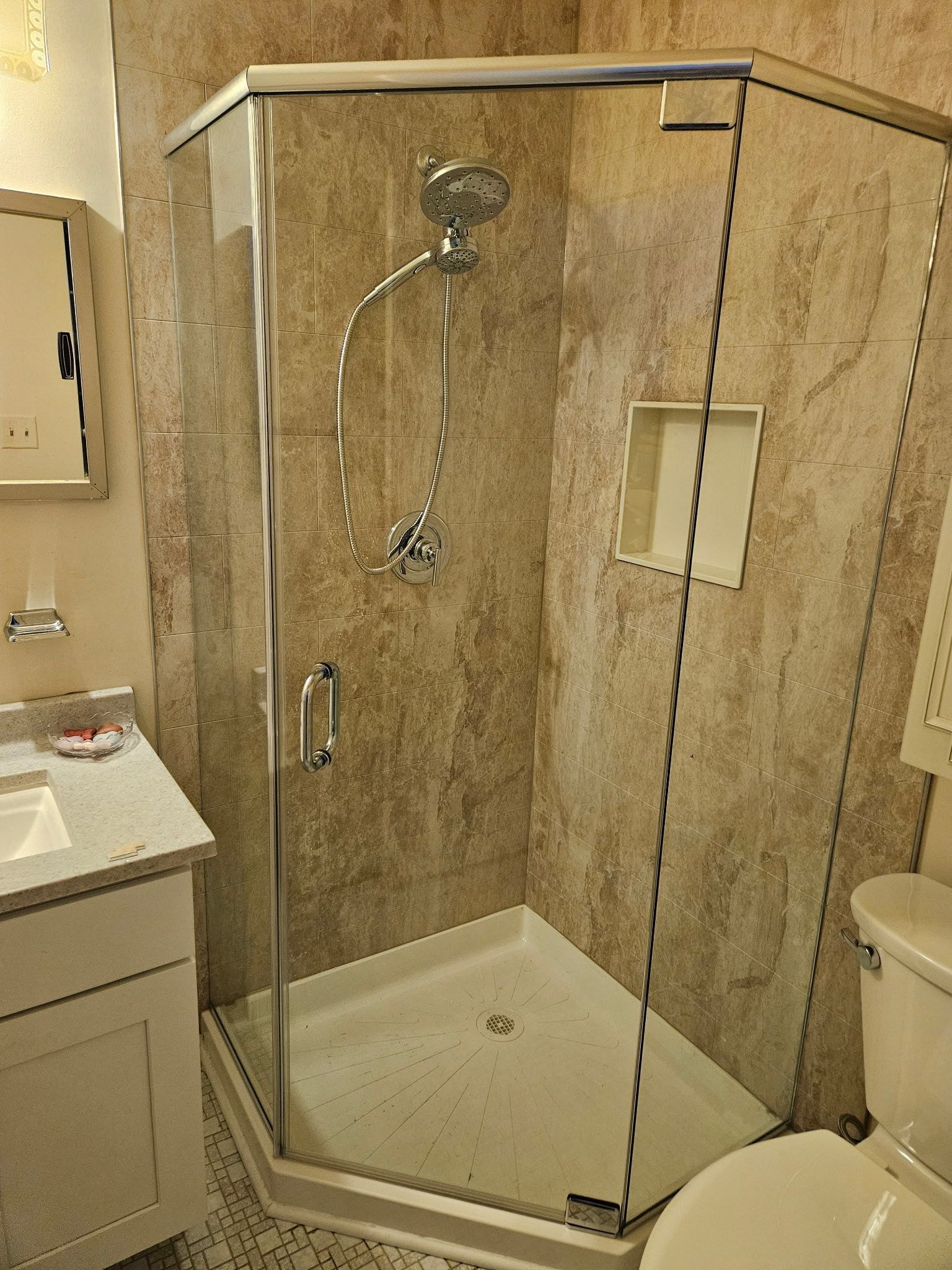 Neo-angle shower enclosure with clear glass and chrome hardware in Baltimore, MD