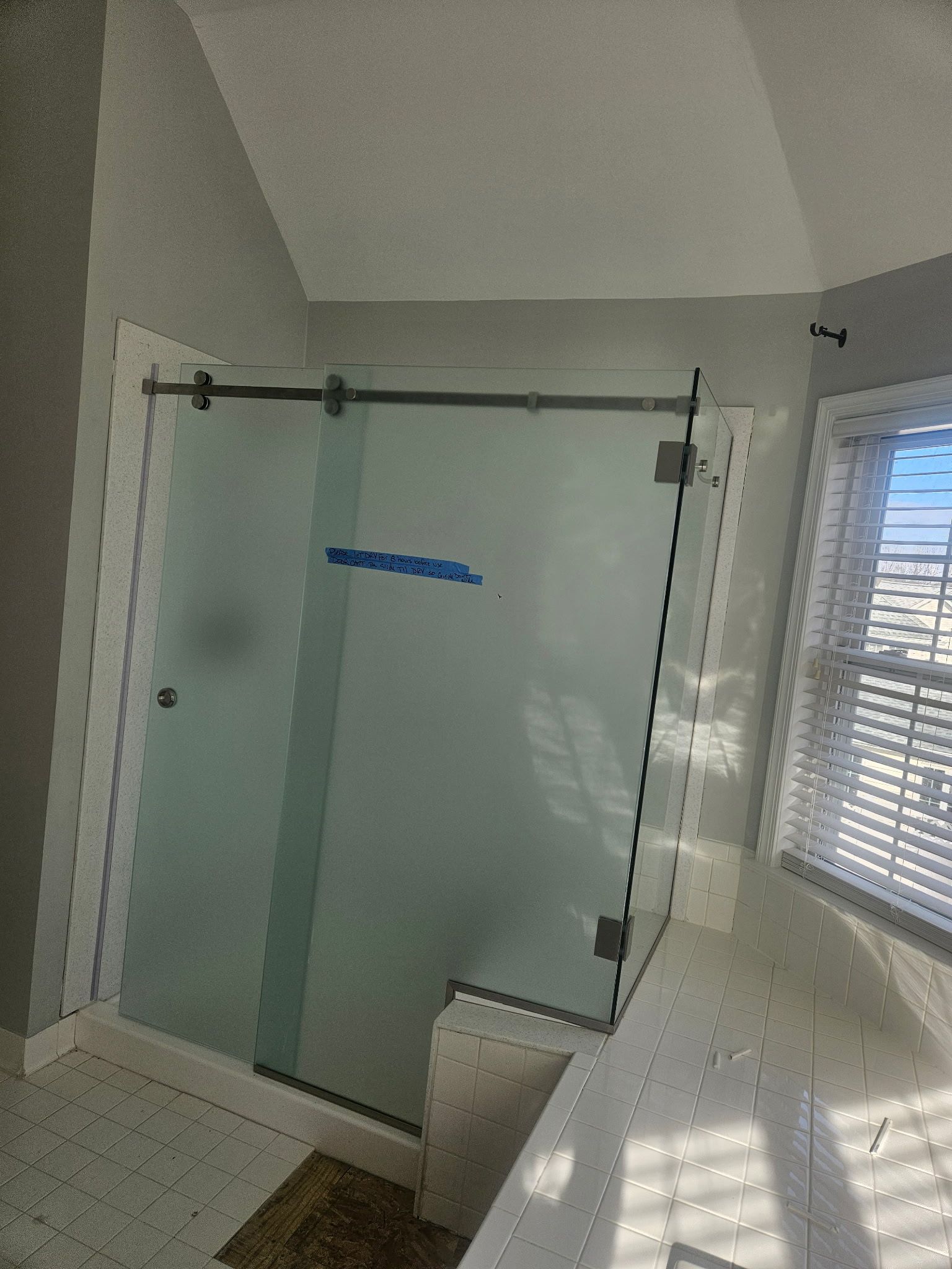 Frosted glass sliding shower enclosure with matte black hardware in Baltimore, MD
