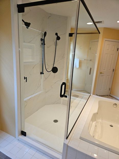 Matte black framed hinged shower door with D-pull handle