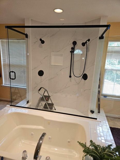 Tub deck shower enclosure with matte black header bars