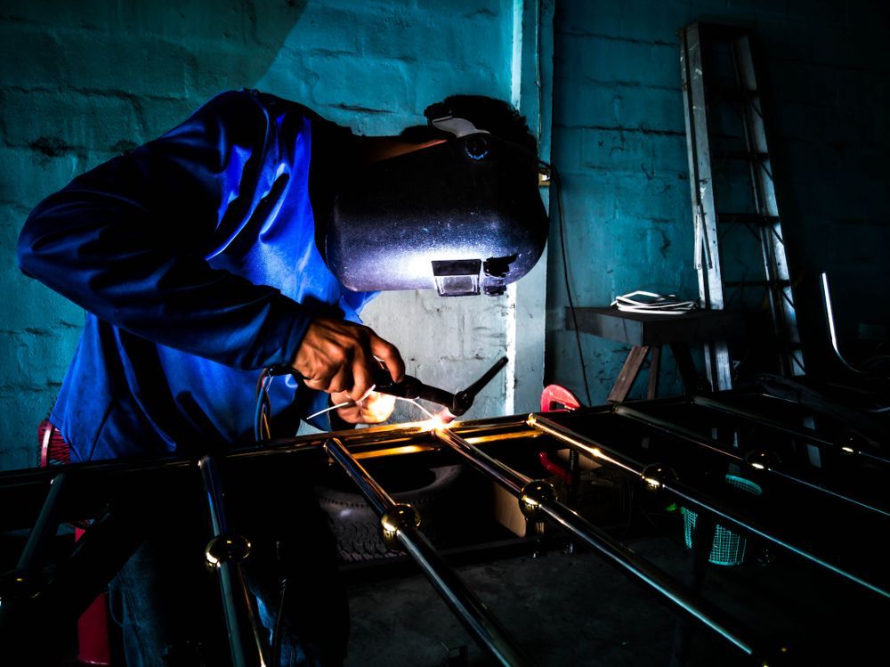 Mechanic Works a Welding Aluminum Door With an Electric Welding Machine — Steel & Aluminium Welding in Ballina, NSW