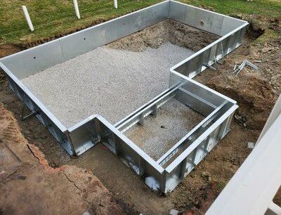 A metal frame is sitting on top of a pile of gravel.