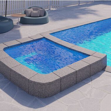 A large swimming pool with a smaller pool in the middle