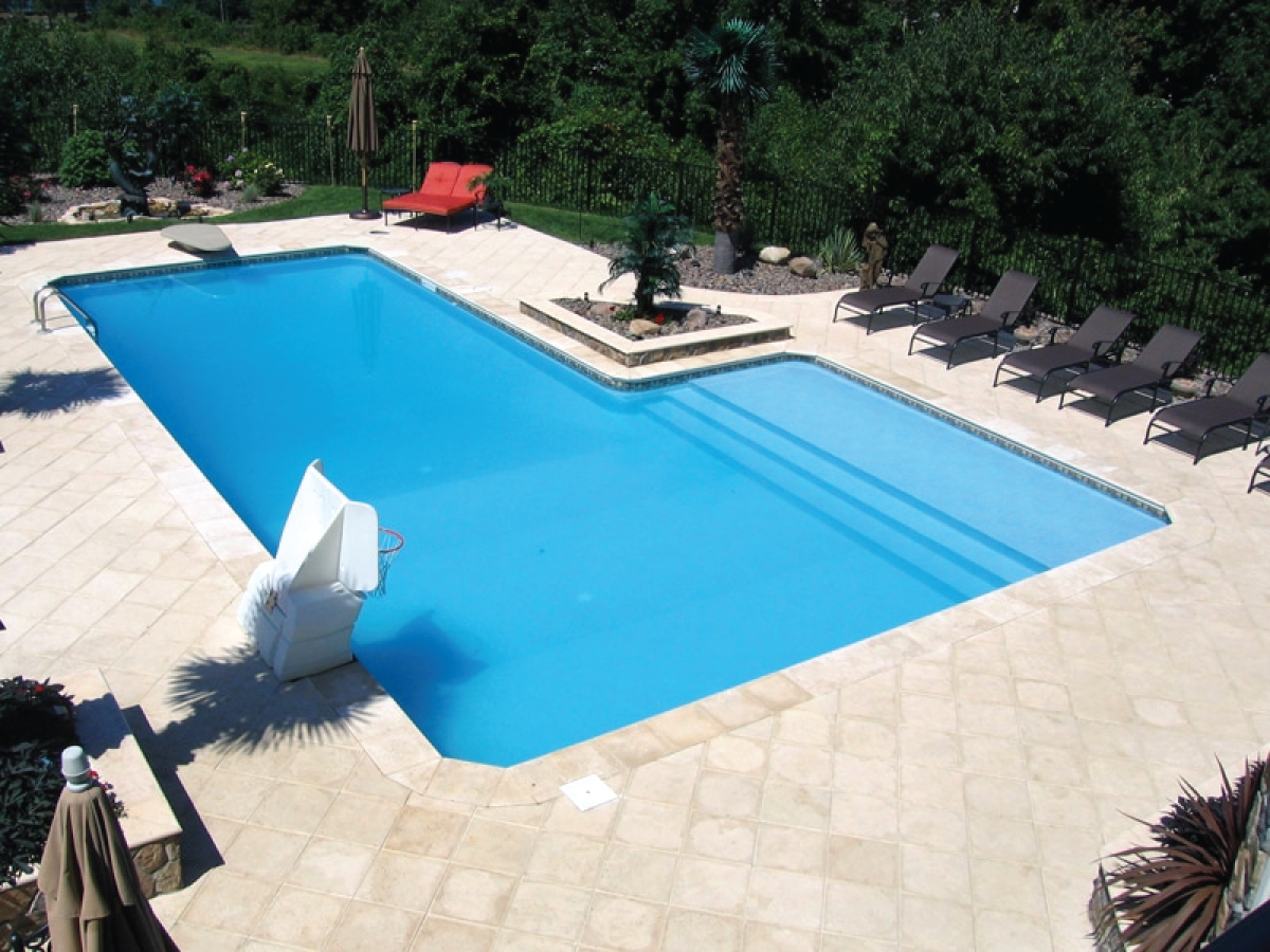 A large swimming pool surrounded by chairs and trees