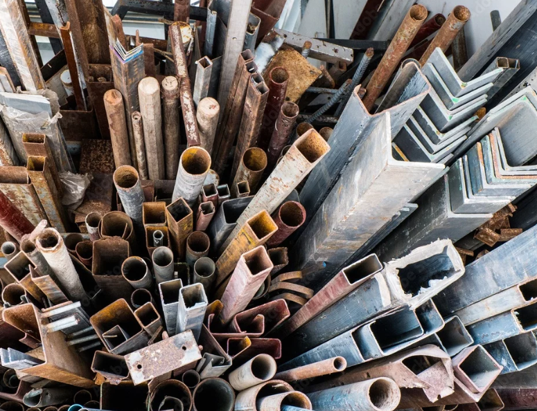 Scrap metal collection of assorted rusted pipes and steel pieces.