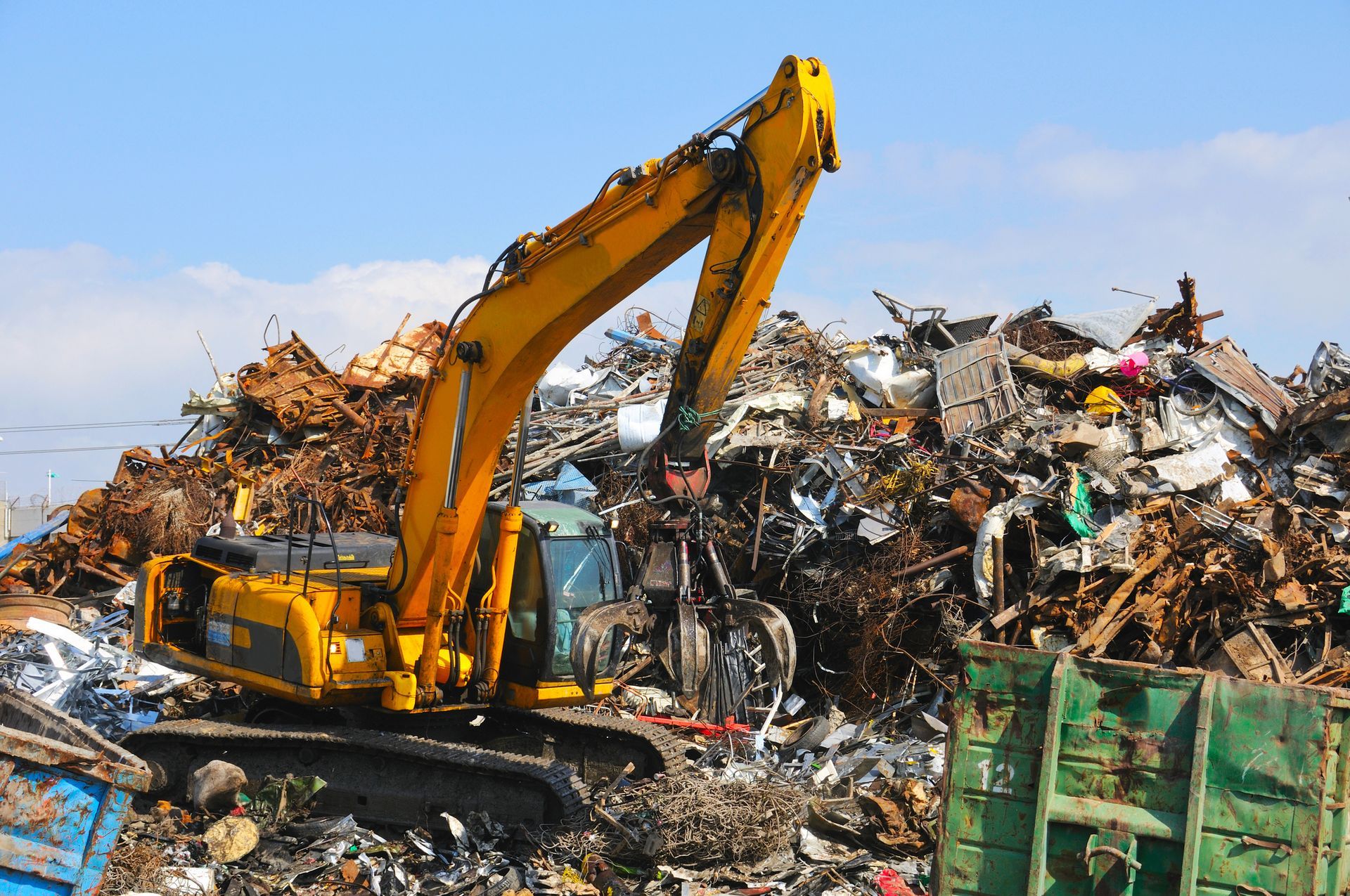 Metal recycling crane from American Scrap Metal piling scrap metal near Alsip, IL.