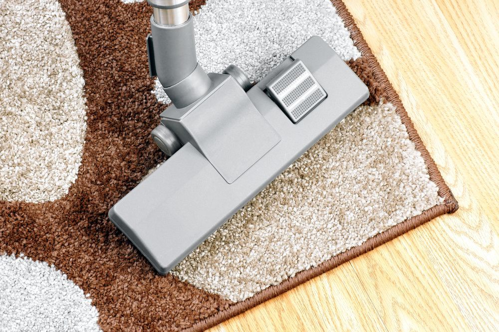 Vacuum Cleaner Head Cleaning Carpet Beside Hardwood Floor Edge — Broadbeach Carpet Cleaning In Main Beach, QLD