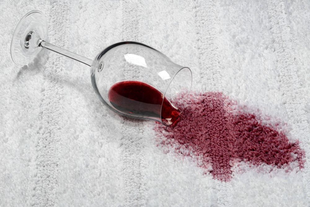 Spilled Red Wine From a Tipped-over Glass on a Light Gray Surface — Broadbeach Carpet Cleaning In Broadbeach, QLD