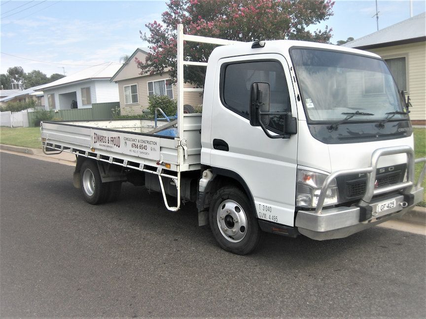A White Truck Is Parked on The Side of The Road — Edwards & Froud Building Services Pty Ltd in Armidale, NSW