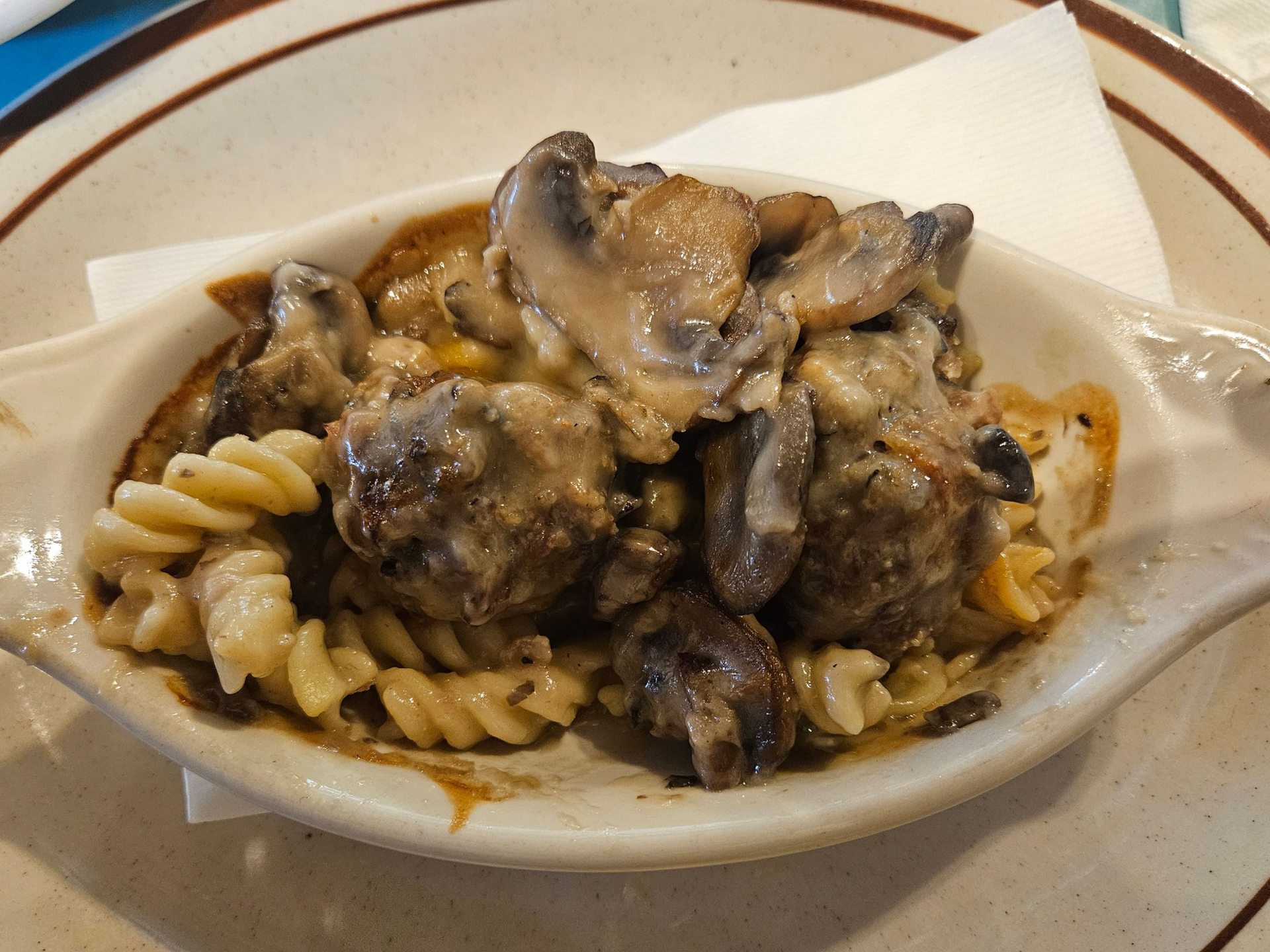 Creamy mushroom gravy overtop wild rice and sausage meatballs, served over pasta