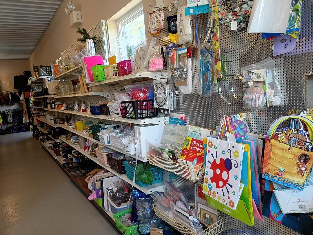 Gift shop aisle with colorful bags, toys, and souvenirs on shelves