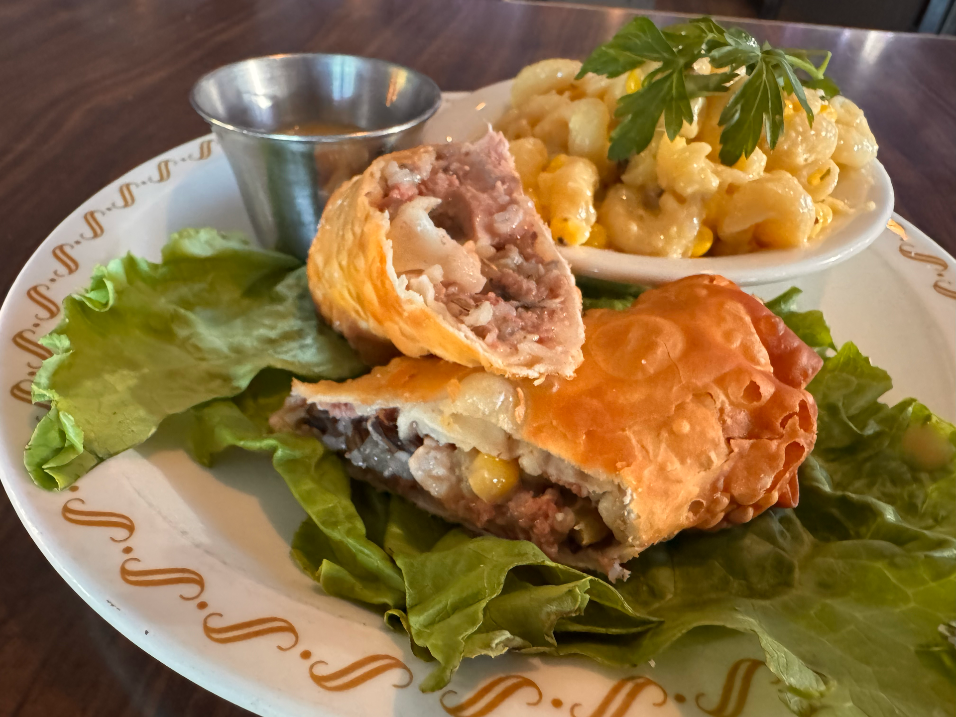 Two meat and wild rice-filled egg rolls and corn pasta
