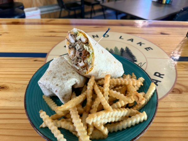 Wrap and crinkle fries on a teal plate on a wooden table