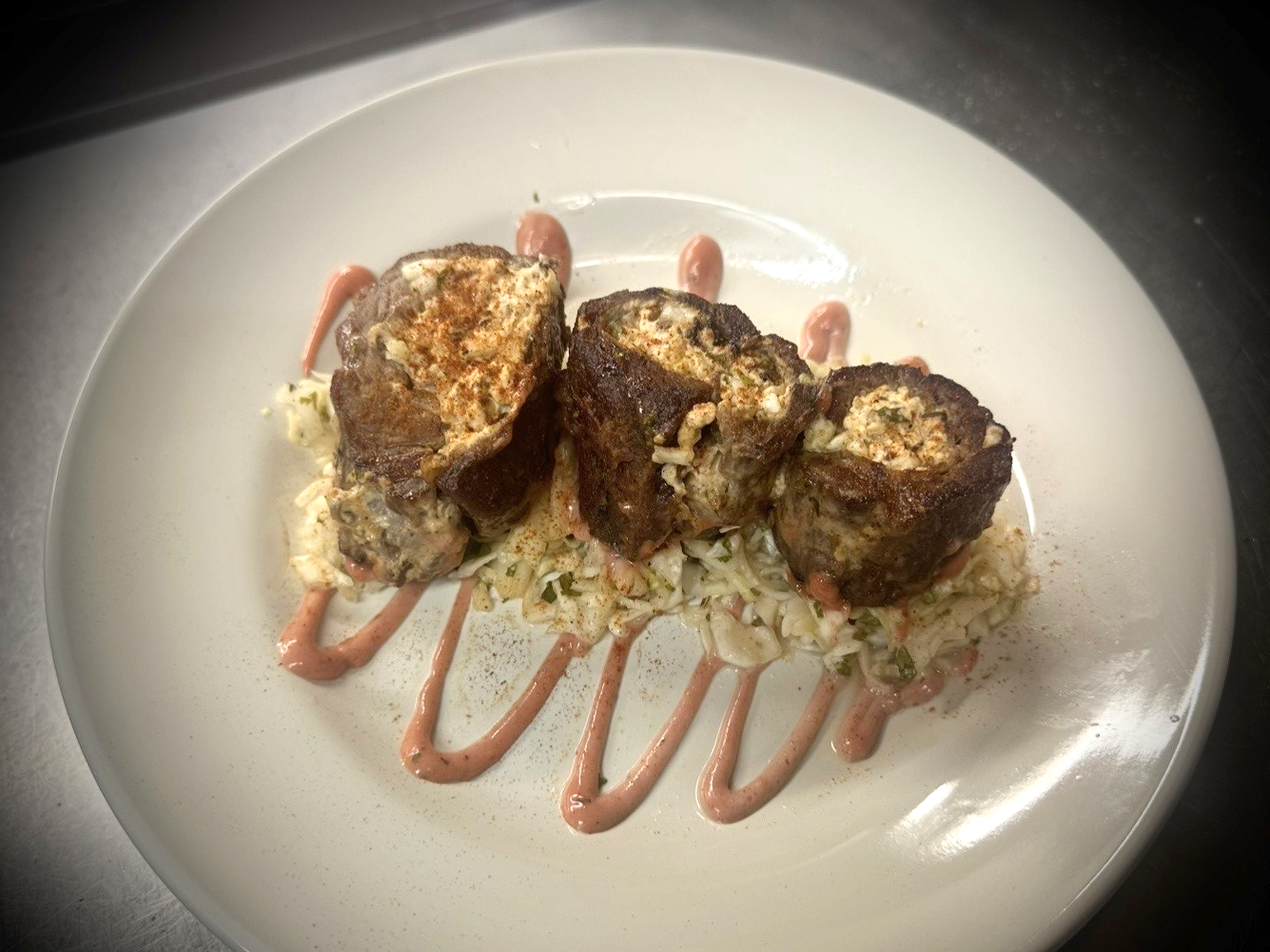 Steak rollup with wild rice and corn stuffing
