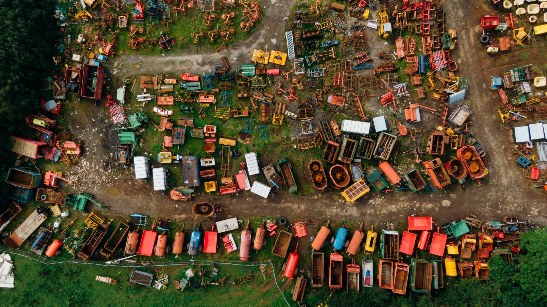 Aerial view of a crowded outdoor auction at a farm.