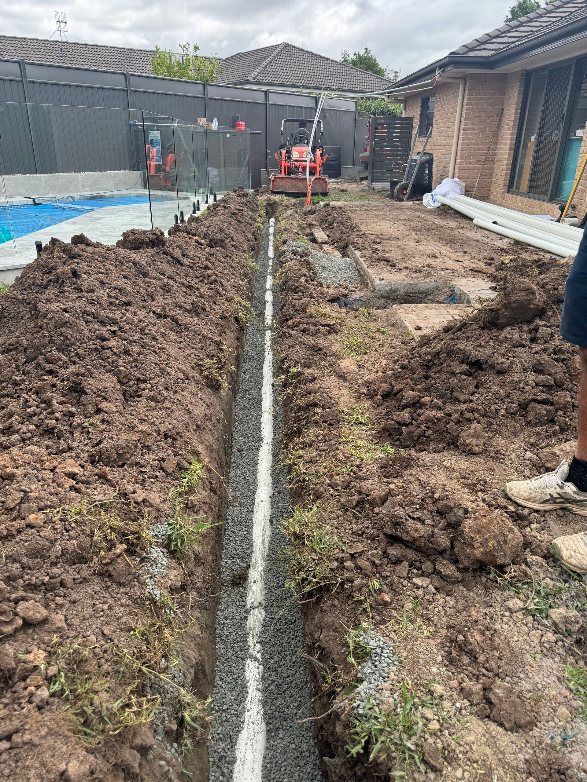 New external sewer drainage installed near a swimming pool in a residence — All About Quality Plumbing Services In Halekulani, NSW