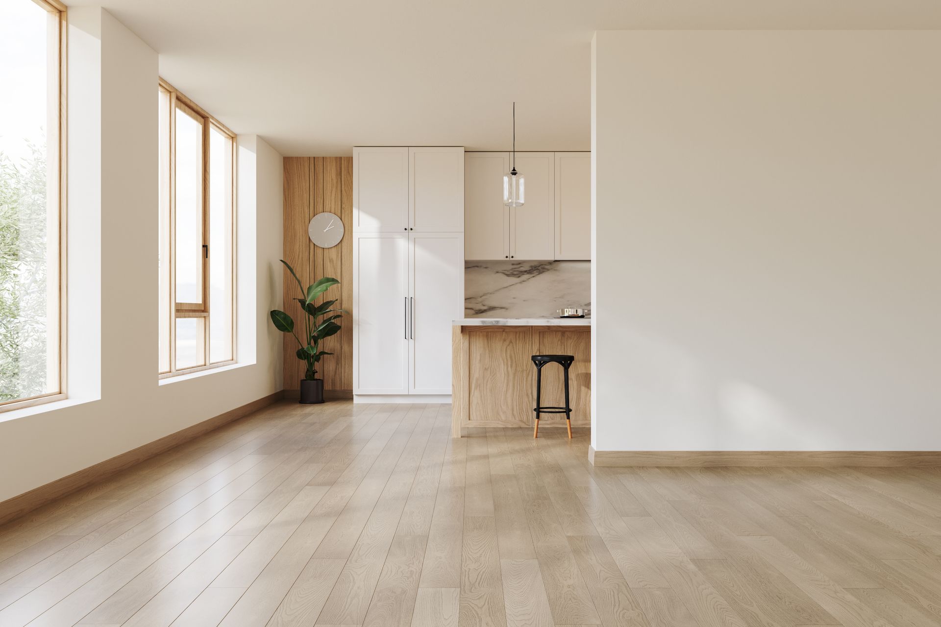 Bright empty apartment with wood floors, large windows, and a small kitchen nook