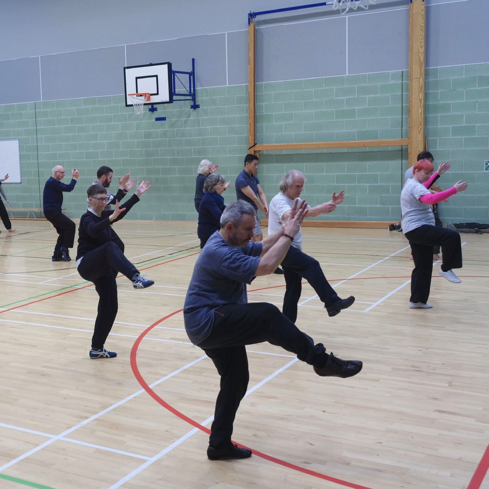 A group of people are practicing martial arts in a gym Tai Chi Chuan Edinburgh
