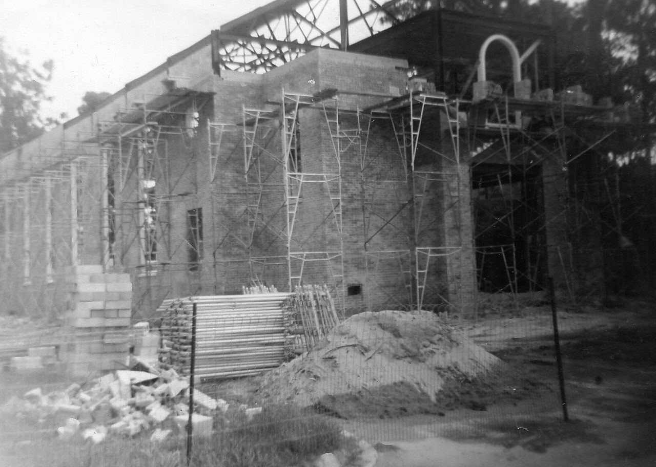 Building under construction with scaffolding and materials.