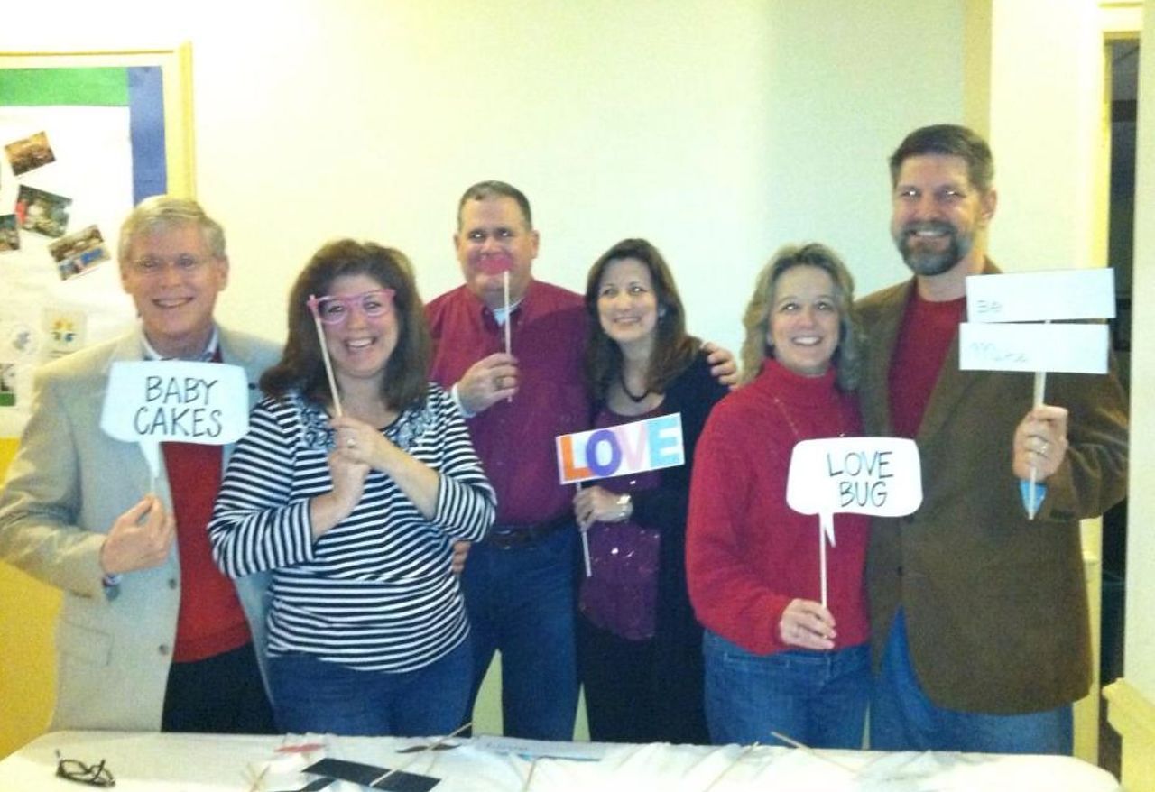 Group of six people holding signs with words: 