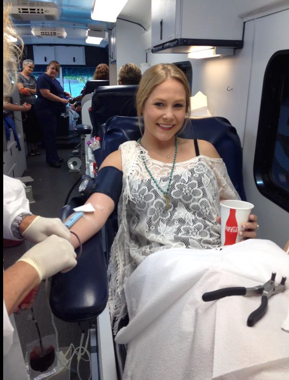 Woman donating blood in a mobile blood donation center