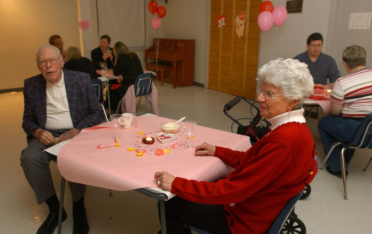 People at a party, seated around tables. 