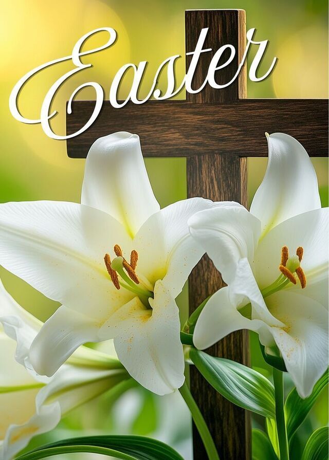White Easter lilies in front of a wooden cross against a bright, blurred green and yellow background.