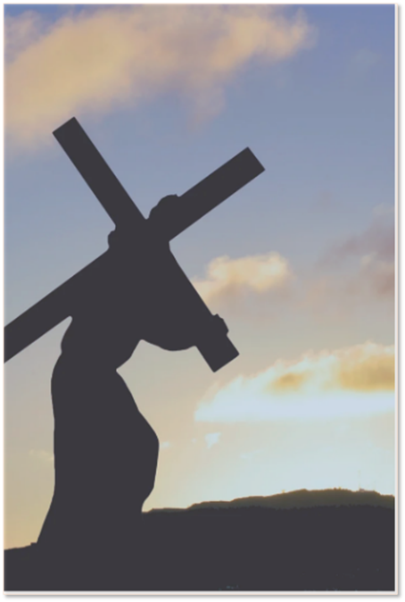 Silhouette of a person walking up a hill while carrying a large wooden cross against a soft, sunset-colored sky.