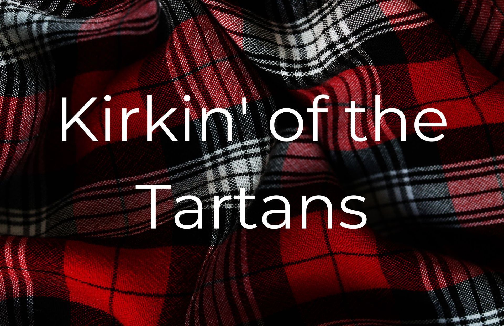 Red and black tartan fabric with the words 