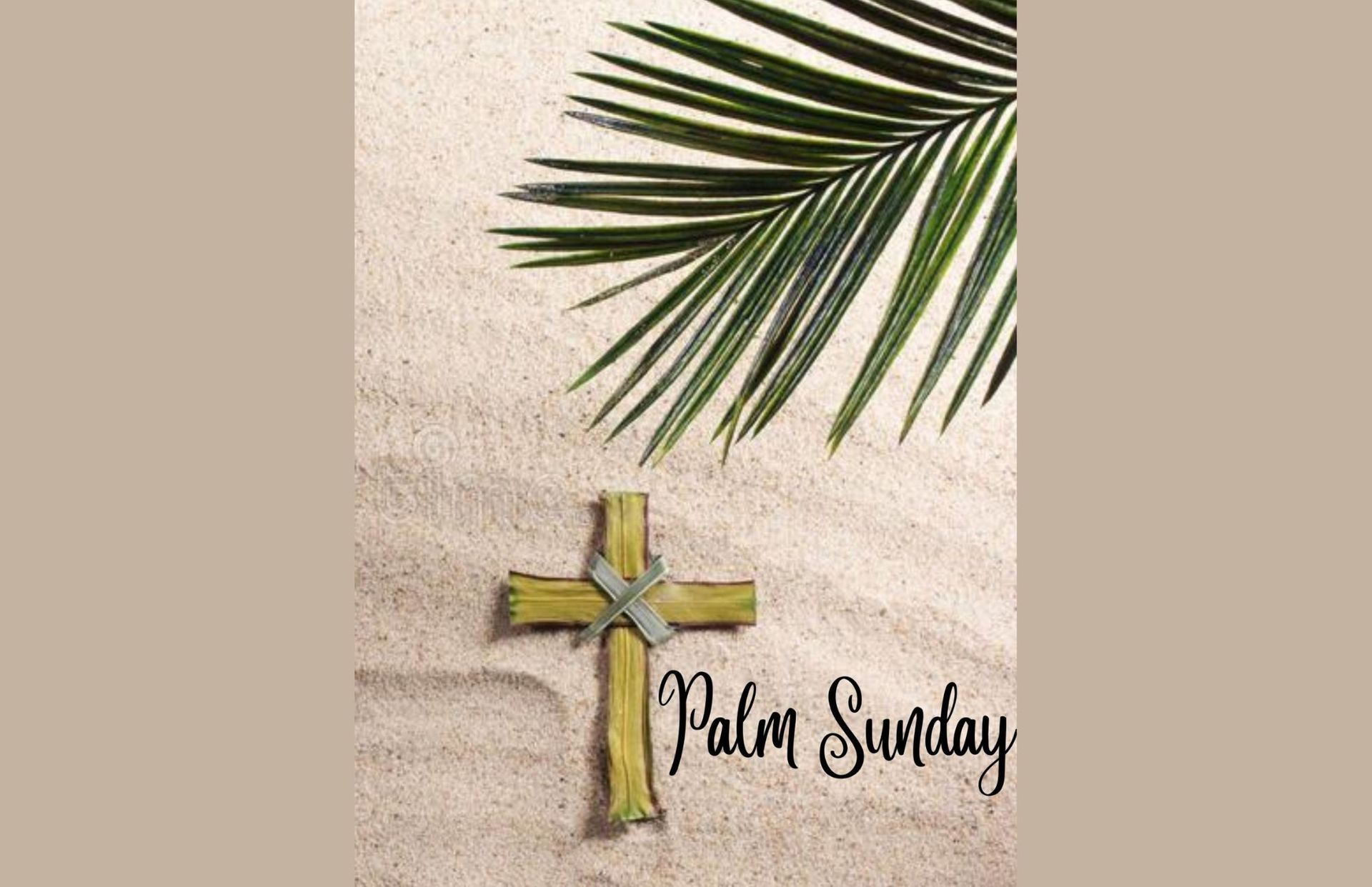 Palm cross and palm frond on sand, 