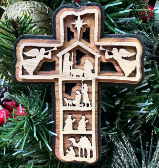 Wooden cross Christmas ornament with a layered Nativity scene; angels, star, figures, and animals.