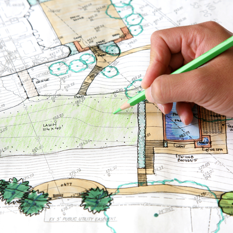 a person is drawing a map with a green pencil