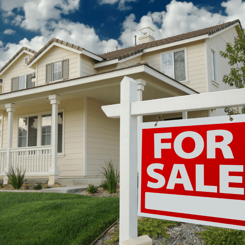 a house with a for sale sign in front of it