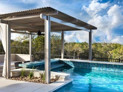 A large swimming pool with a pergola over it