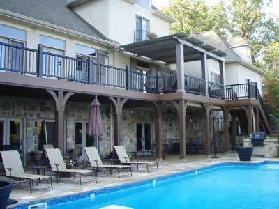 A large house with a large swimming pool in front of it