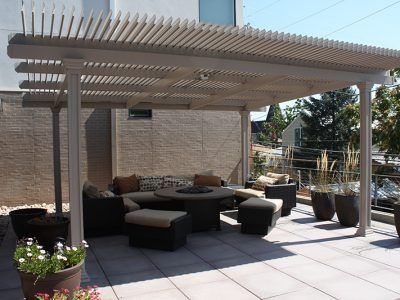 A patio with a table and chairs under a pergola