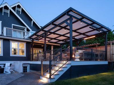 A house with a covered deck and stairs leading up to it