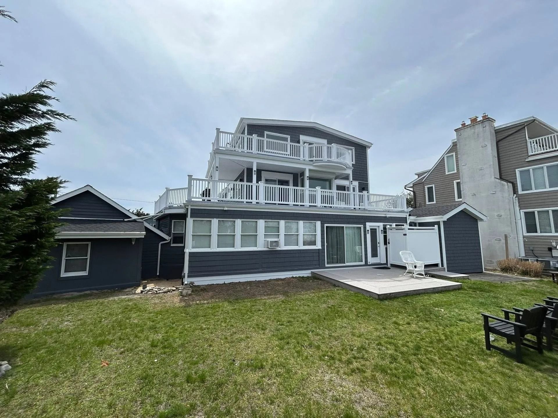 Two-story painted gray siding house with white trim, deck, in ocean city, nj