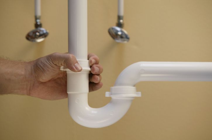 Plumber adjusting plumbing pipe for drain cleaning in Columbus, OH | Calhoun Plumbing