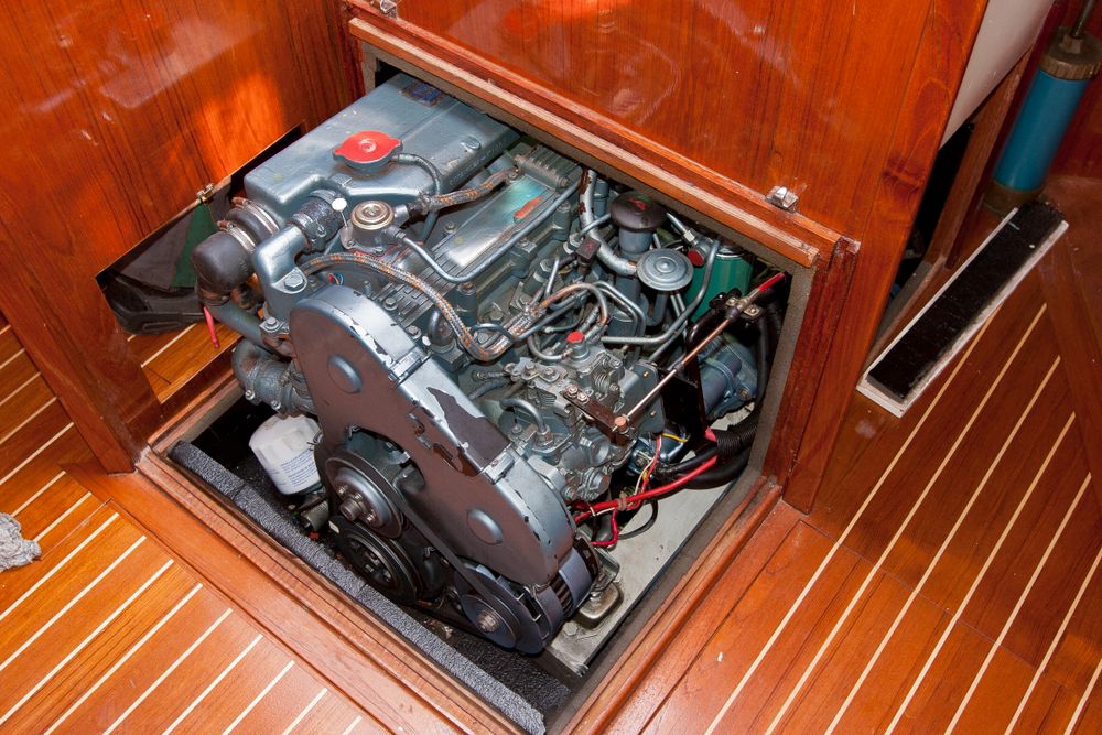 A Boat Engine is Sitting Underneath a Wooden Floor — Ashby Boat Builders In Buddina, QLD