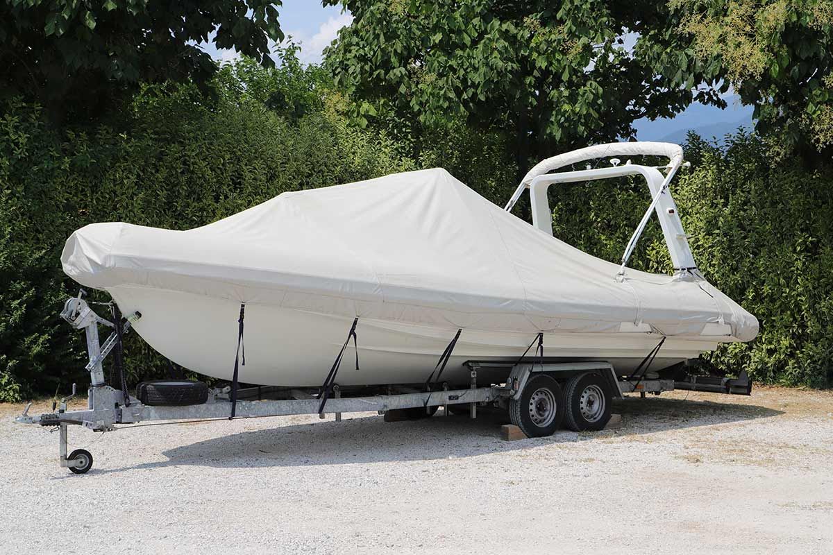 A White Boat Is Covered in A White Cover on A Trailer — Ashby Boat Builders In Buddina, QLD
