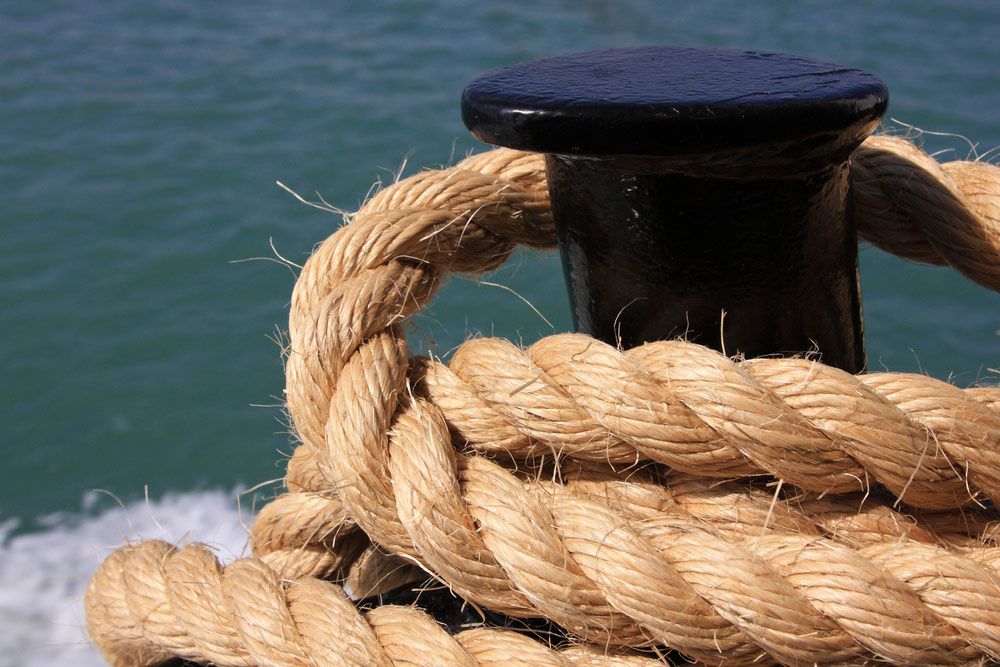 A Close up Of a Rope Tied Around a Pole in The Water — Ashby Boat Builders In Buddina, QLD