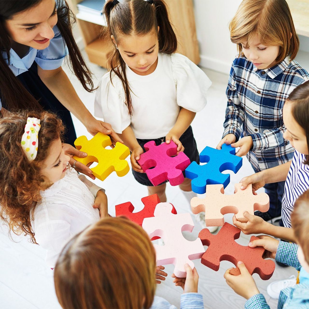 A group of children are playing with puzzle pieces.
