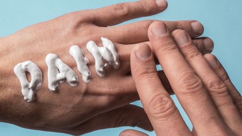 Hand applying cream spelling
