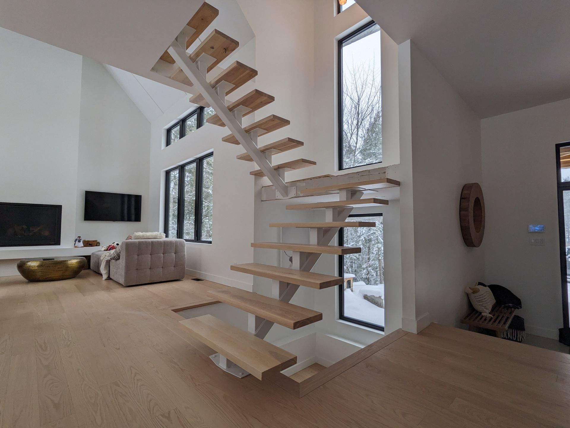 Un escalier en bois mène au deuxième étage d'une maison.