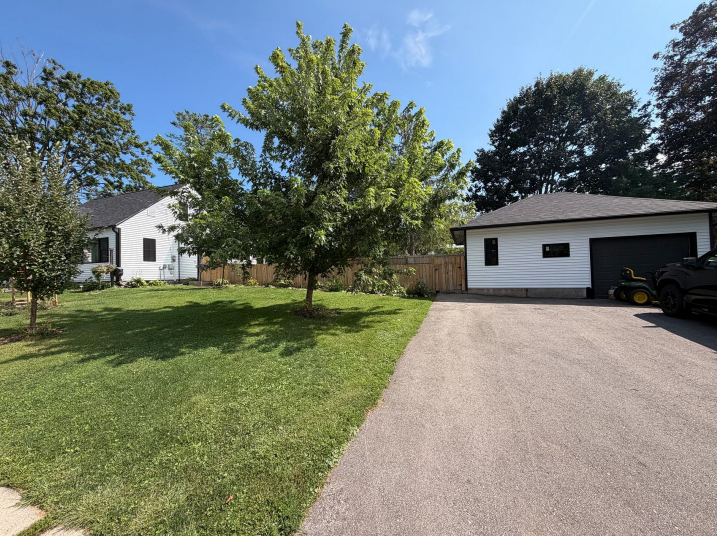 White siding and new roofs on a residential property in Lansing, IA.