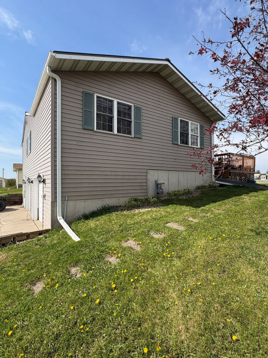 Side profile of a home with gray siding in Lansing, IA.